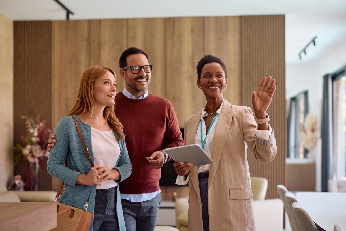 Real estate agent showing a property to a couple during a home tour